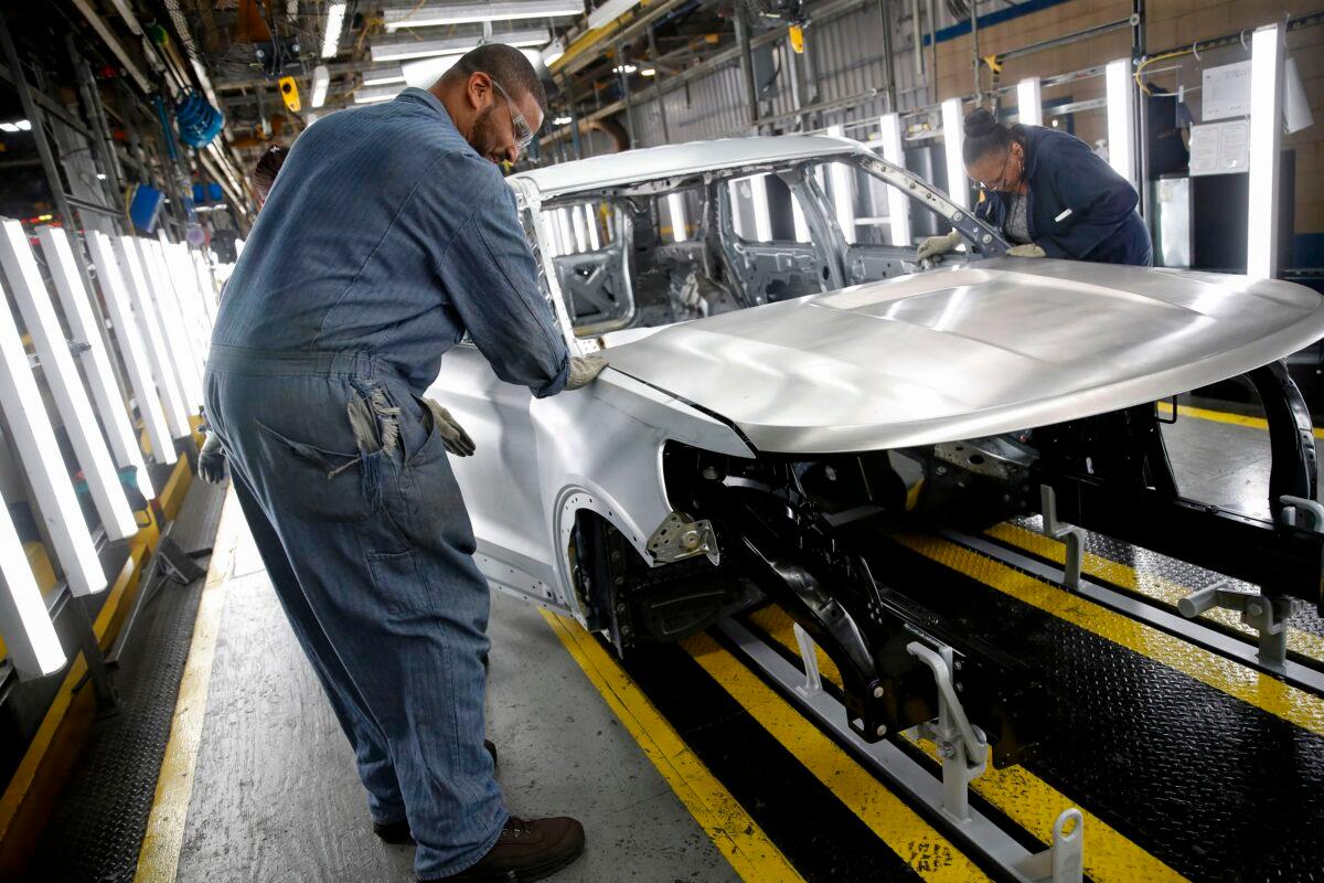 Workers assemble cars at the newly retooled Ford Assembly Plant in Chicago on June 24, 2019. (Jim Young/AFP via Getty Images)