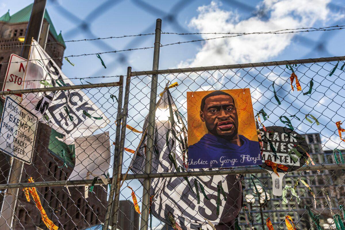 A poster with George Floyd's picture and a sign that reads "I Can't Breathe" hang from a security fence outside the Hennepin County Government Center in Minneapolis, Minn. on March 31, 2021. (Kerem Yucel/AFP via Getty Images)