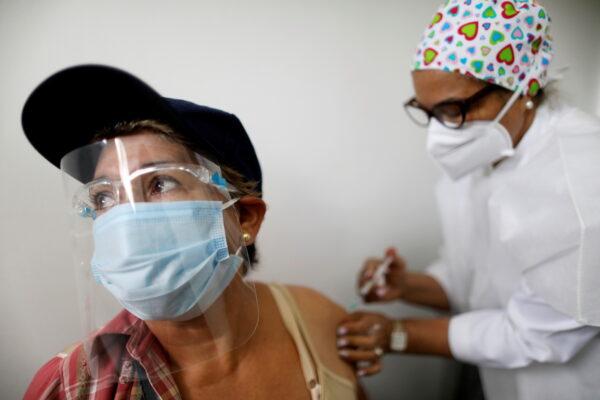 An elderly woman receives a dose of Russia's Sputnik V coronavirus disease (COVID-19) vaccine in Caracas, Venezuela on April 9, 2021. (Leonardo Fernandez Viloria/REUTERS)