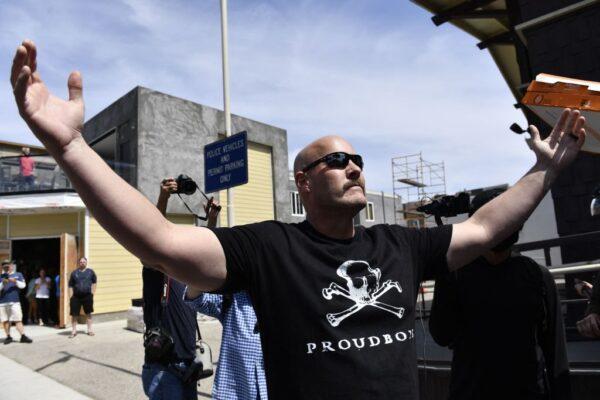 A person wears a Proud Boys T-shirt as demonstrators face off during a counter-protest organized against a rumored "White Lives Matter" rally in Huntington Beach, Calif., on April 11, 2021. (Patrick T. Fallon/AFP via Getty Images)