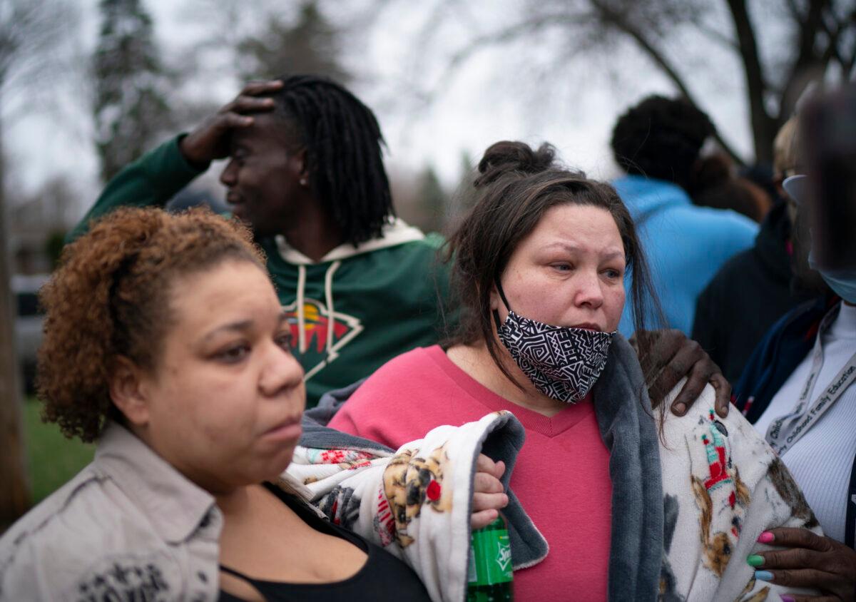 Friends and family comfort Katie Wright, right, while she speaks briefly to news media near where her son Daunte Wright, 20, was shot by a police officer after resisting arrest in Brooklyn Center, Minn., on April 11, 2021. (Jeff Wheeler/Star Tribune via AP)