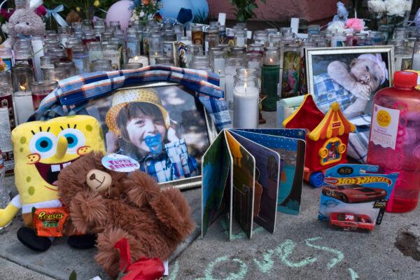 Photos, candles, flowers and balloons are placed as a memorial for three children who were killed at the Royal Villa apartments complex in the Reseda section of Los Angeles, on April 12, 2021. (Richard Vogel/AP Photo)