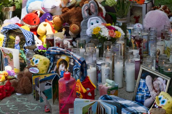 Photos, candles, flowers and balloons are placed as a memorial for three children who were killed at the Royal Villa apartments complex in the Reseda section of Los Angeles, on April 12, 2021. (Richard Vogel/AP Photo)
