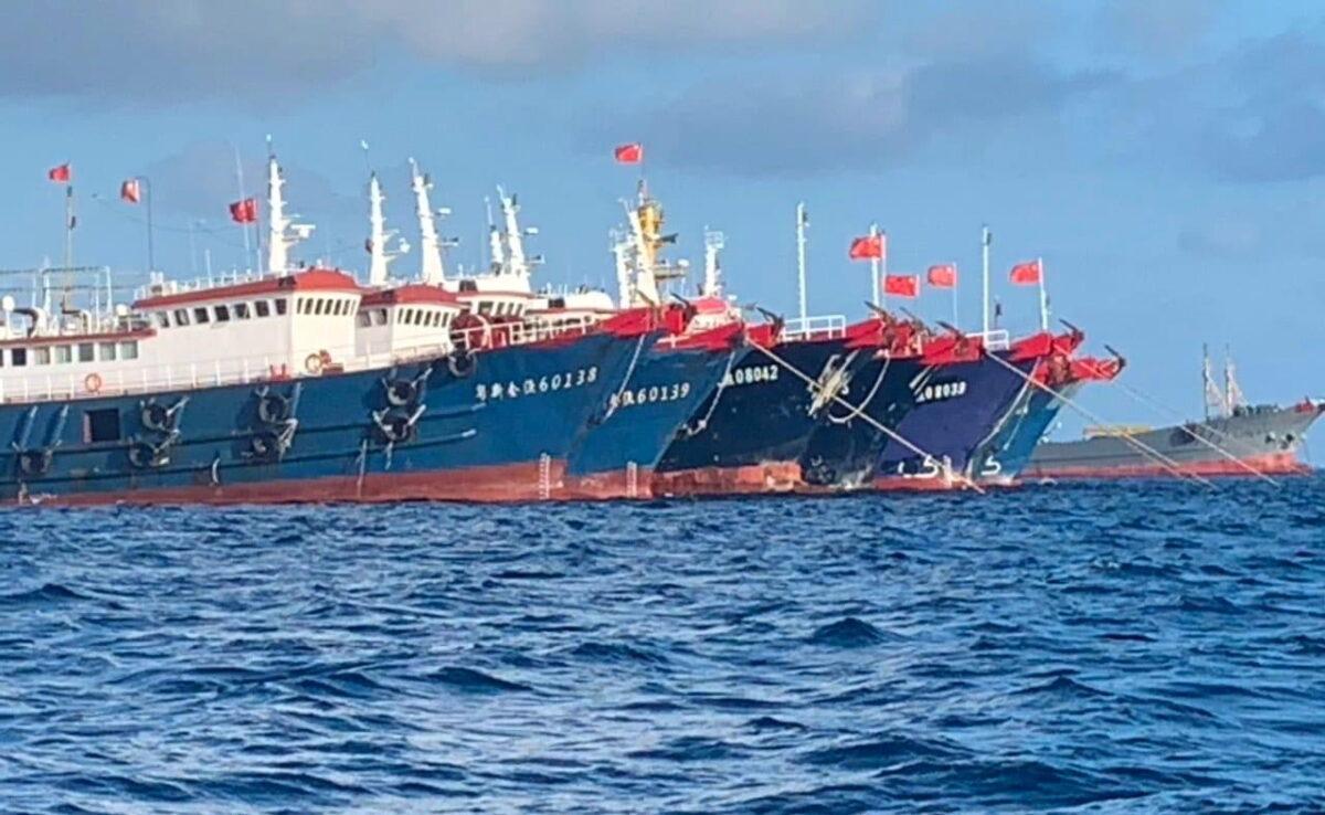 Chinese vessels, believed to be manned by Chinese maritime militia personnel, are seen at Whitsun Reef, South China Sea, on March 27, 2021. (Philippine Coast Guard/Handout via Reuters)