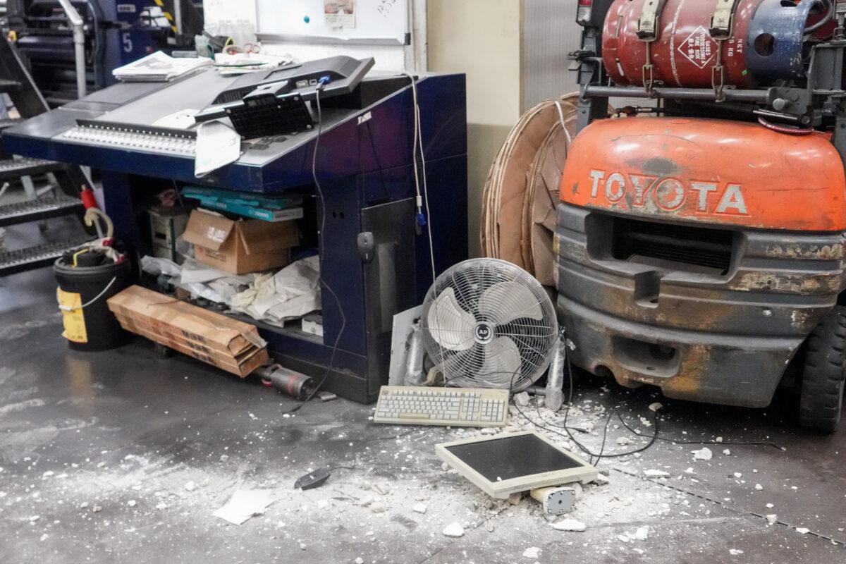 Damaged computers and construction debris on the floor of The Epoch Times Hong Kong edition's printing press in Hong Kong, on April 12, 2021. (Adrian Yu/The Epoch Times)