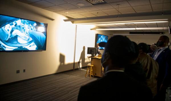 People watch as the body camera footage of the killing of 20-year-old Daunte Wright is played during a press conference at the Brooklyn Center police headquarters in Brooklyn Center, Minnesota, on April 12, 2021. (Stephen Maturen/Getty Images)