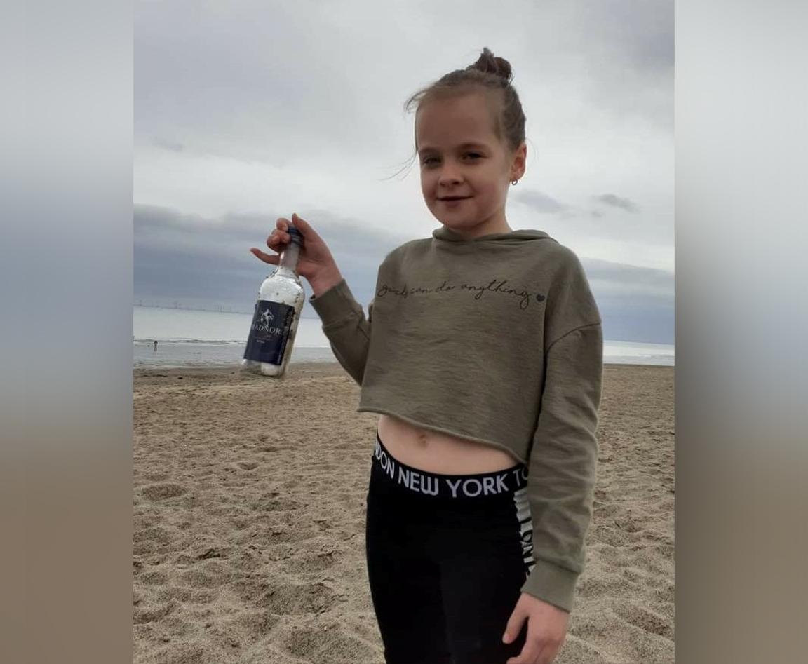 Lilly Carter with her bottle that was found in Norway. (SWNS)