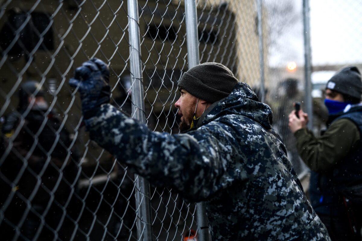 People are seen at the fencing outside the Brooklyn Center police headquarters in Brooklyn Center, Minn., on April 13, 2021. (Stephen Maturen/Getty Images)