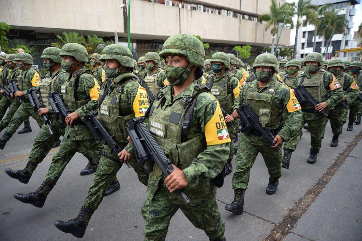 Soldiers march during the announcement of the new measures by the Mexican government to deter illegal crossings at the southern border with Guatemala, in Tuxtla Gutierrez, Mexico, on March 19, 2021. (Jacob Garcia/Reuters)