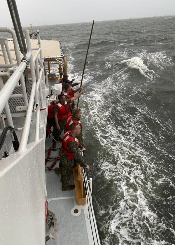 In this photo provided by the U.S. Coast Guard, crew members of the Coast Guard Cutter Glenn Harris search for survivor on April 13, 2021 after a 175-foot commercial lift boat capsized 8 miles south of Grand Isle, La. (U.S. Coast Guard via AP)