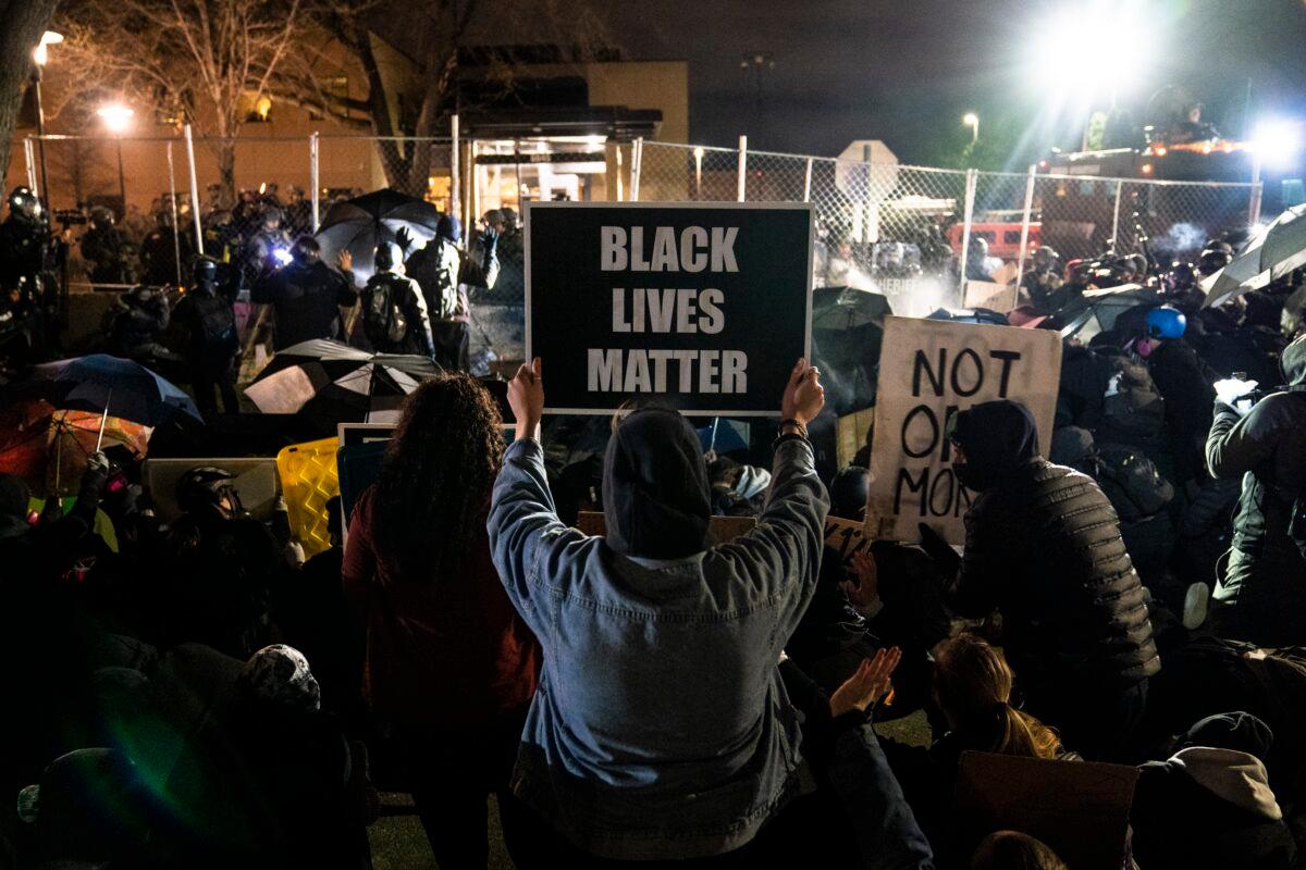 People take part in a demonstration outside the Brooklyn Center Police Department in Brooklyn Center, Minn., on April 14, 2021. (John Minchillo/AP Photo)
