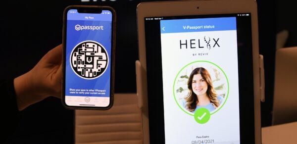 REVIV USA West Coast Operations Manager Kari Armamento uses a cell phone and an iPad to demonstrate the HELIIX Health Passport at REVIV at The Cosmopolitan of Las Vegas, in Las Vegas, Nev., on April 7, 2021. (Ethan Miller/Getty Images)