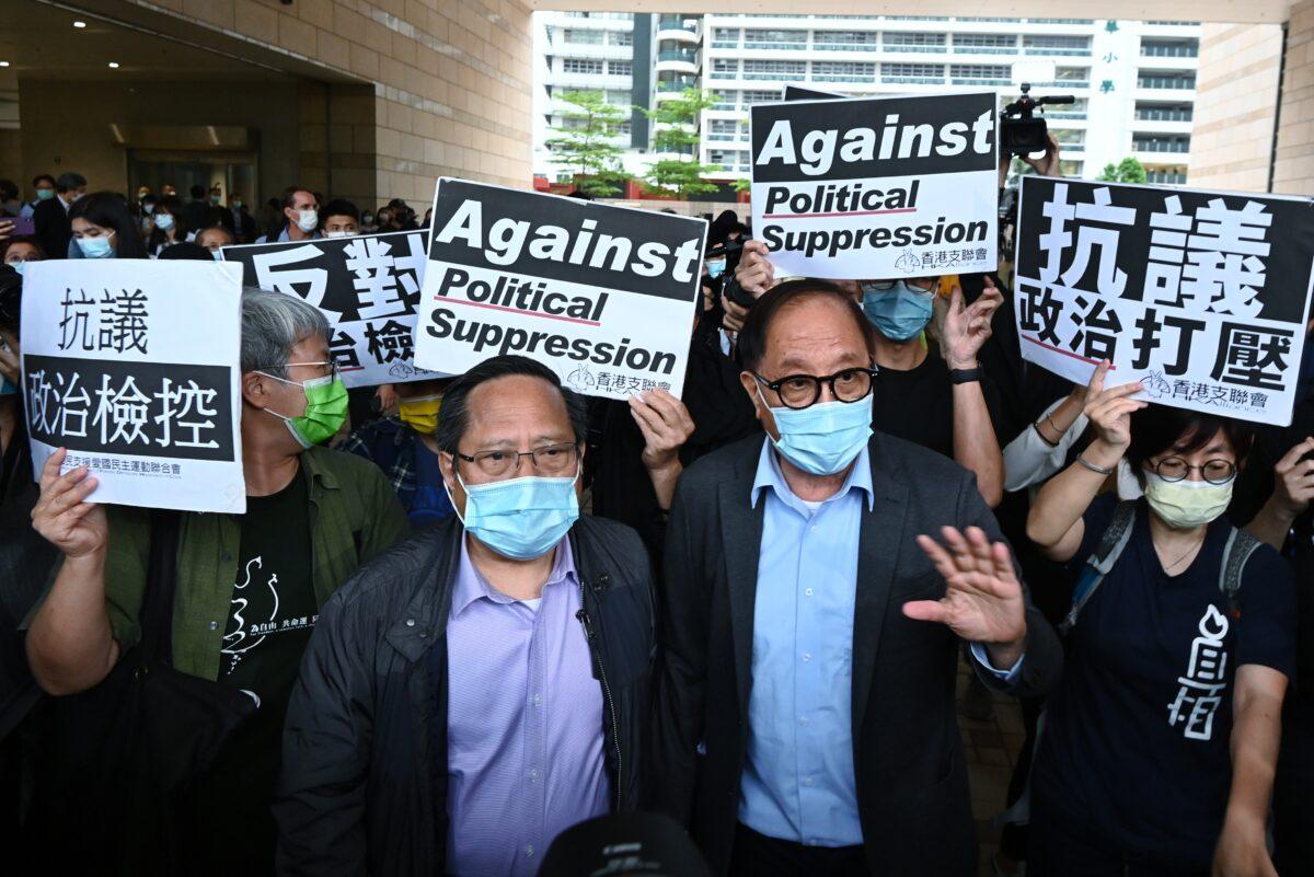 (L-R) Alberto Ho and Yeung Sum leave the West Kowloon court building after being given suspended sentences in Hong Kong on April 16, 2021. (Song Pi-lung/The Epoch Times)