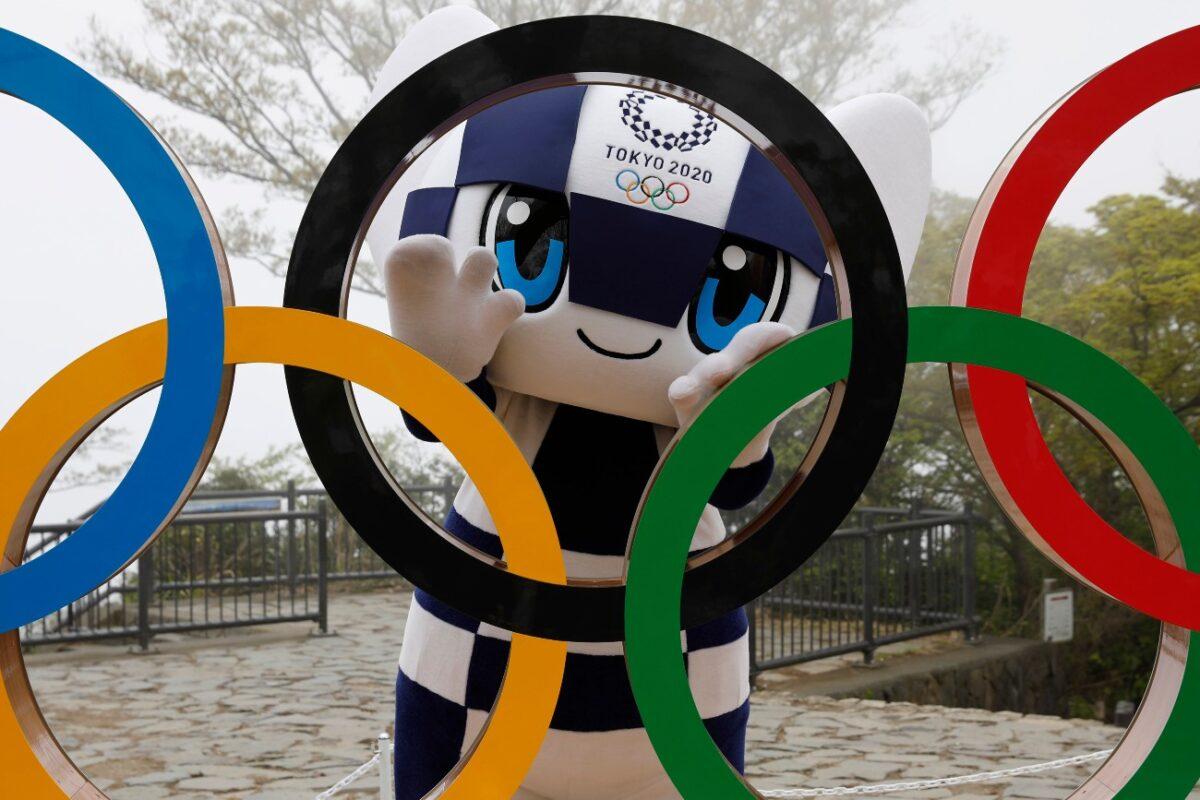 The Tokyo 2020 Olympic Games mascot Miraitowa poses with a display of Olympic Symbol after an unveiling ceremony of the symbol on Mt. Takao in Hachioji, west of Tokyo to mark 100 days before the start of the Olympic Games, on April 14, 2021. (Kim Kyung-Hoon/Pool Photo via AP)