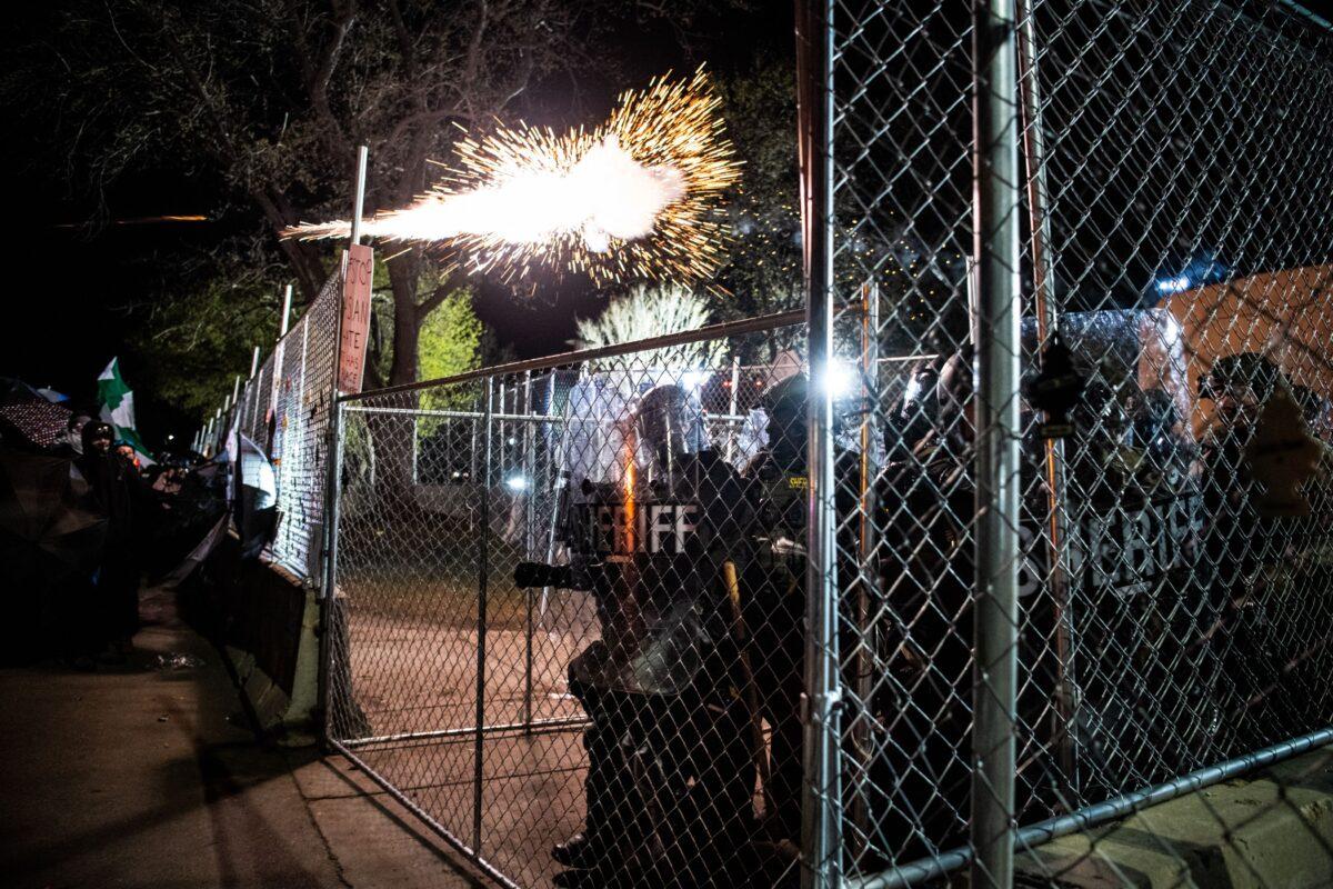 People face crowd control measures from a group of law enforcement officers after trying to tear down fencing around the Brooklyn Center Police Department, in Brooklyn Center, Minn., on April 16, 2021. (Chandan Khanna/AFP via Getty Images)