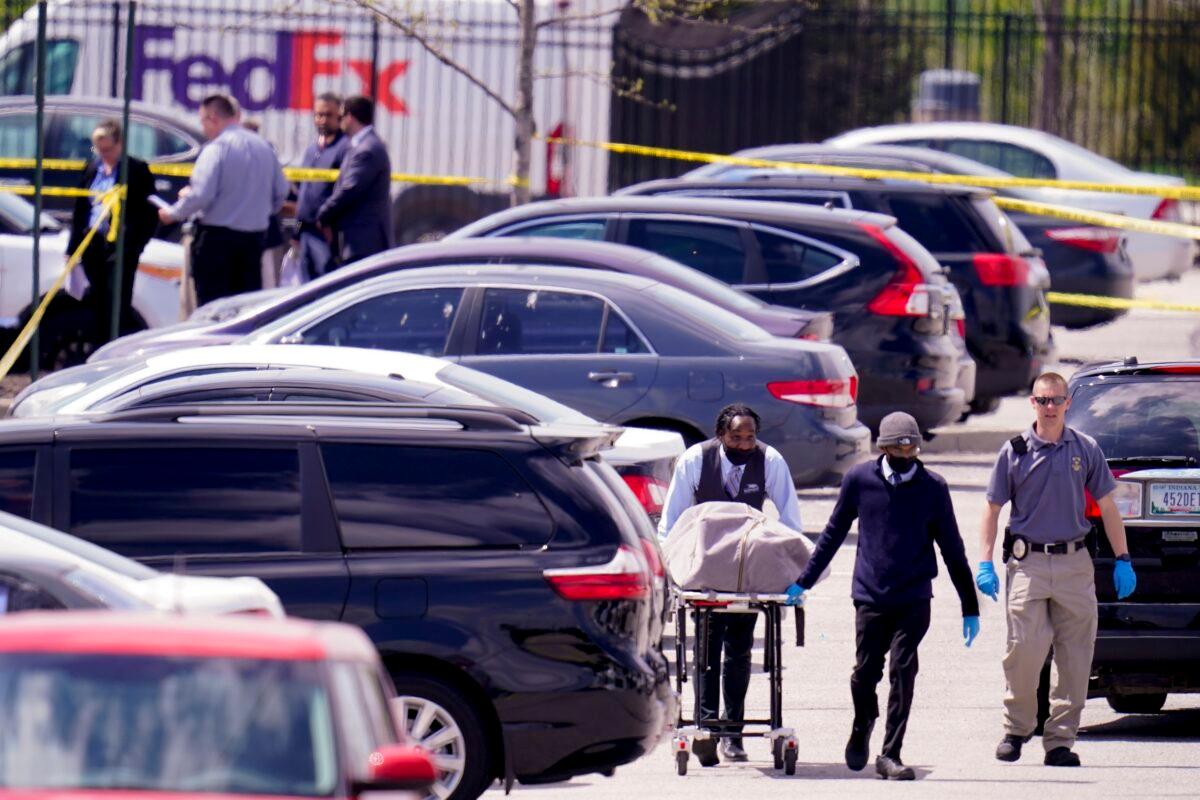 A body is taken from the scene where multiple people were shot at a FedEx Ground facility in Indianapolis, Ind., on April 16, 2021. (Michael Conroy/AP Photo)