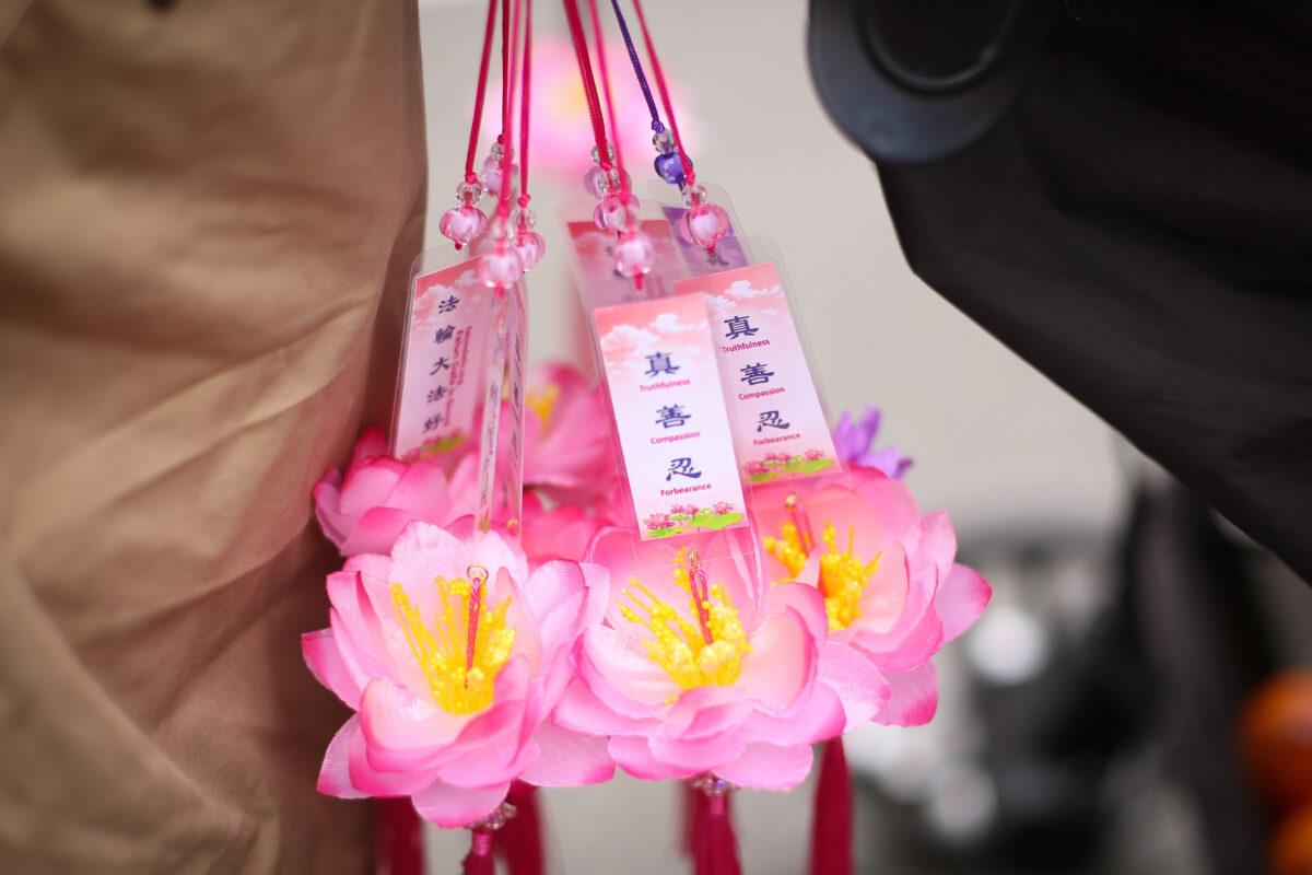 Lotus flowers Charmes to be handed out by Falun Gong practitioners at a parade in Flushing, New York, on April 18, 2021. (Samira Bouaou/The Epoch Times)