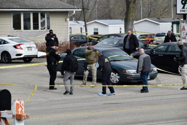 Investigators confer outside the Somers House tavern in Somers, Wis., on April 18, 2021. (Deneen Smith/The Kenosha News via AP)