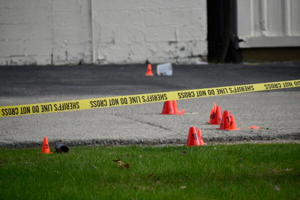 Evidence markers and police tape were in abundance outside the Somers House Tavern and down 15th Place, where shots were fired in a fatal shooting, in Kenosha, Wis., on April 18, 2021. (Deneen Smith/The Kenosha News via AP)