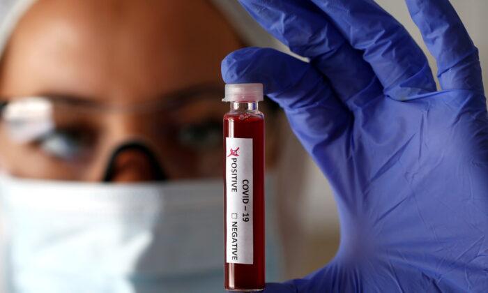 Fake blood is seen in test tubes labelled with the coronavirus (COVID-19) in this illustration taken on March 17, 2020. (Dado Ruvic/Illustration/Reuters)