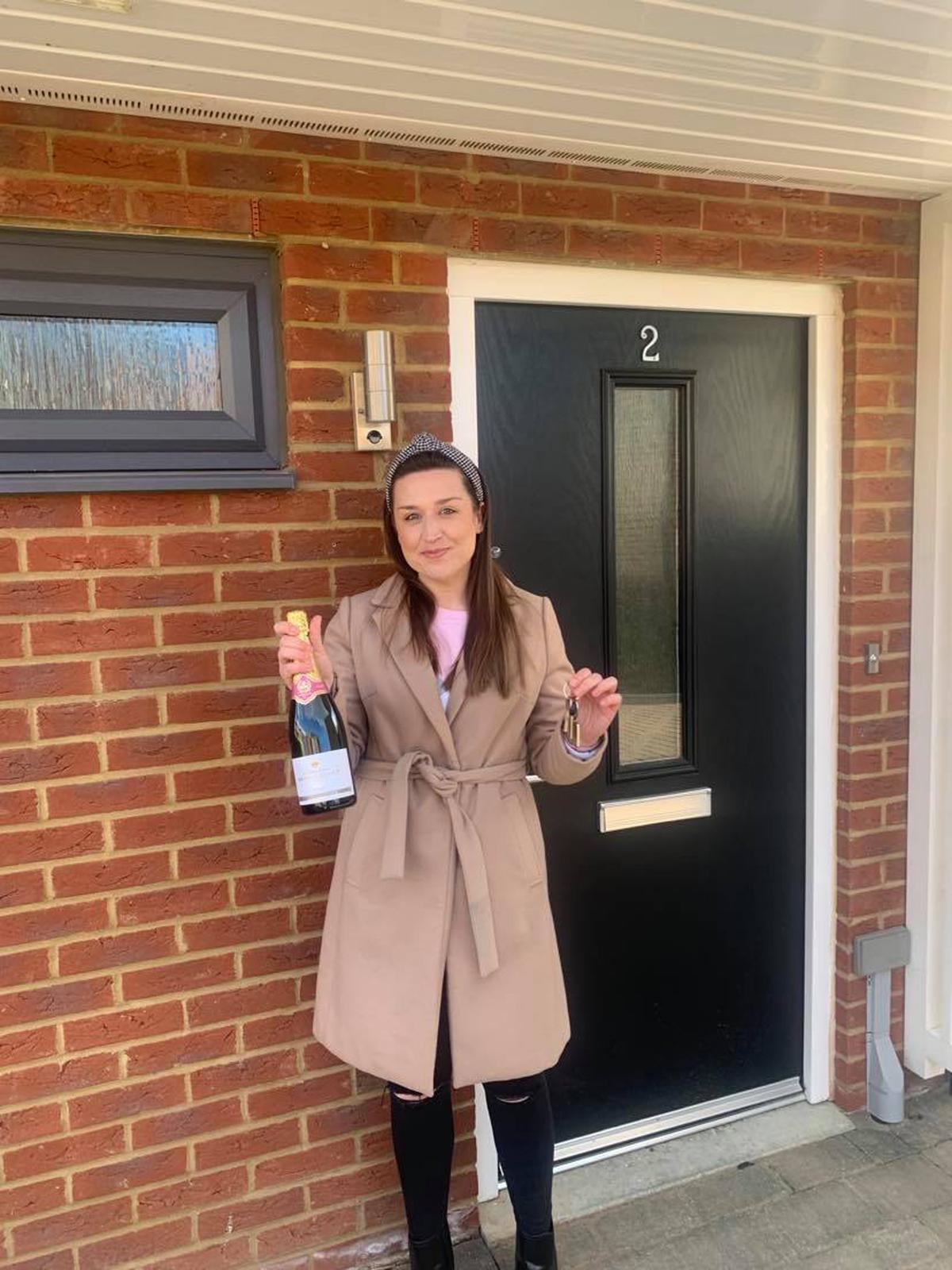 Louise outside their home the day they got the keys. (Caters News)