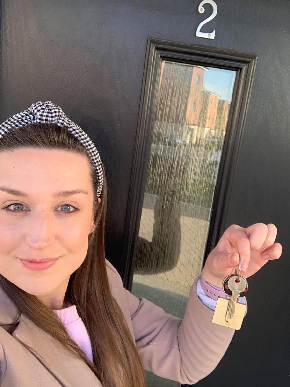 Louise with the keys to their first property. (Caters News)