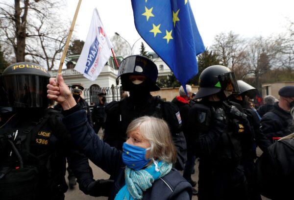 A woman waves a European Union flag in front of Russian Embassy in Prague, Czech Republic, on April 18, 2021. (Petr David Josek/AP Photo)