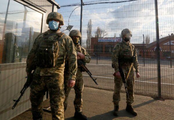 Ukrainian soldiers guard a check point at the town Shshastya, Ukraine, on April 16, 2021. (Efrem Lukatsky/AP Photo)