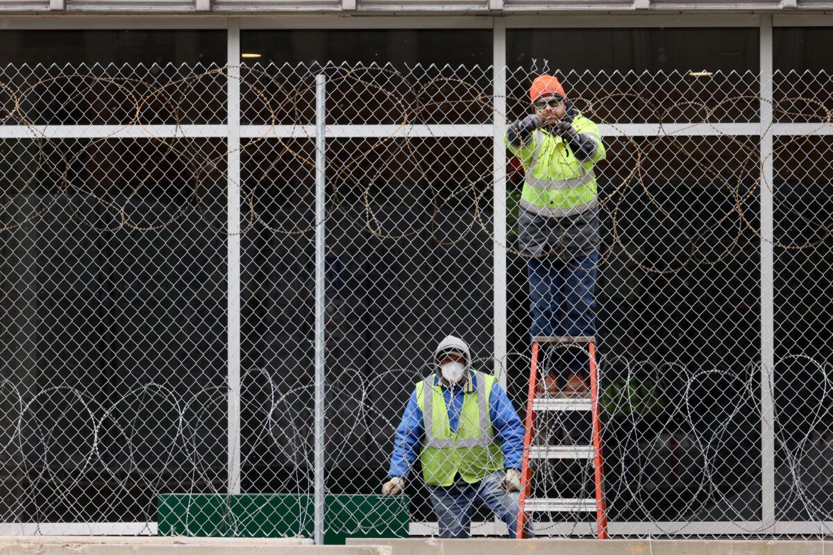 Workers fortify government buildings downtown as the city prepares for possible unrest following the verdict in the Derek Chauvin murder trial, in Minneapolis, Minn., on April 19, 2021. (Scott Olson/Getty Images)