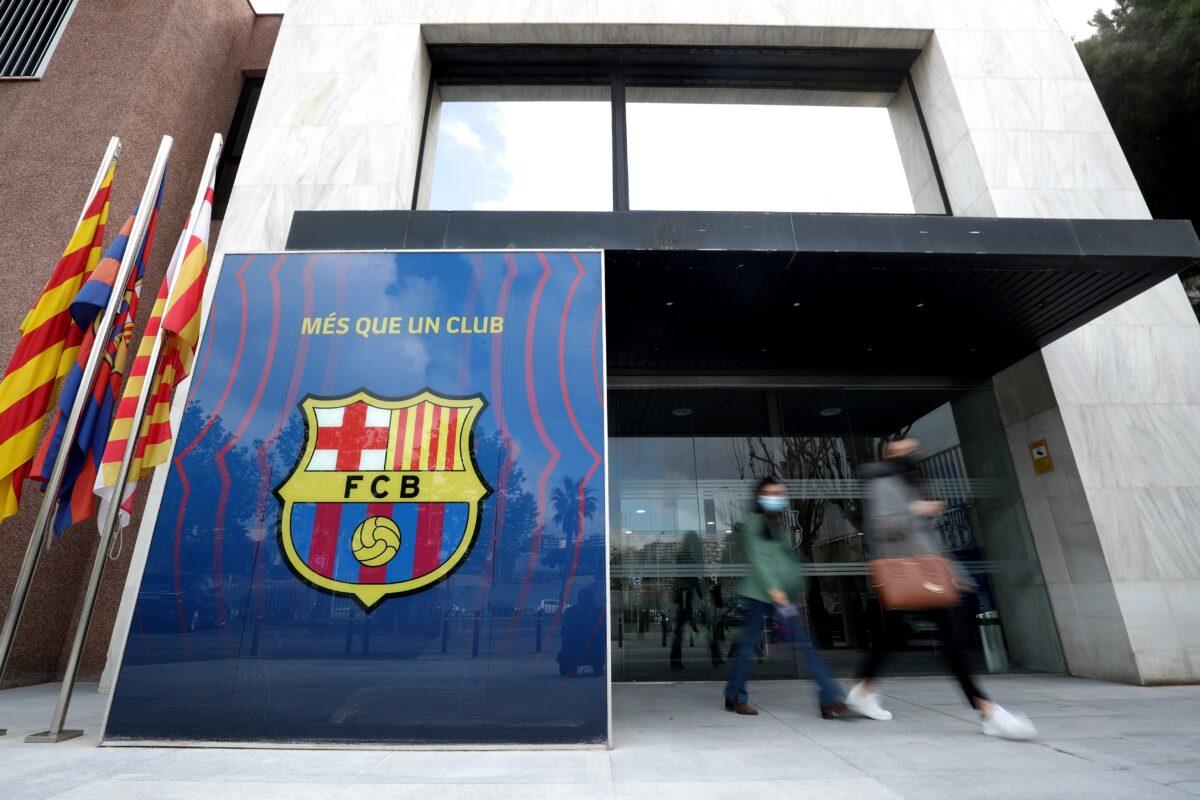 People leave the office of FC Barcelona as twelve of Europe's top football clubs launch a breakaway Super League, Barcelona, Spain, on April 19, 2021. (Albert Gea/Reuters)
