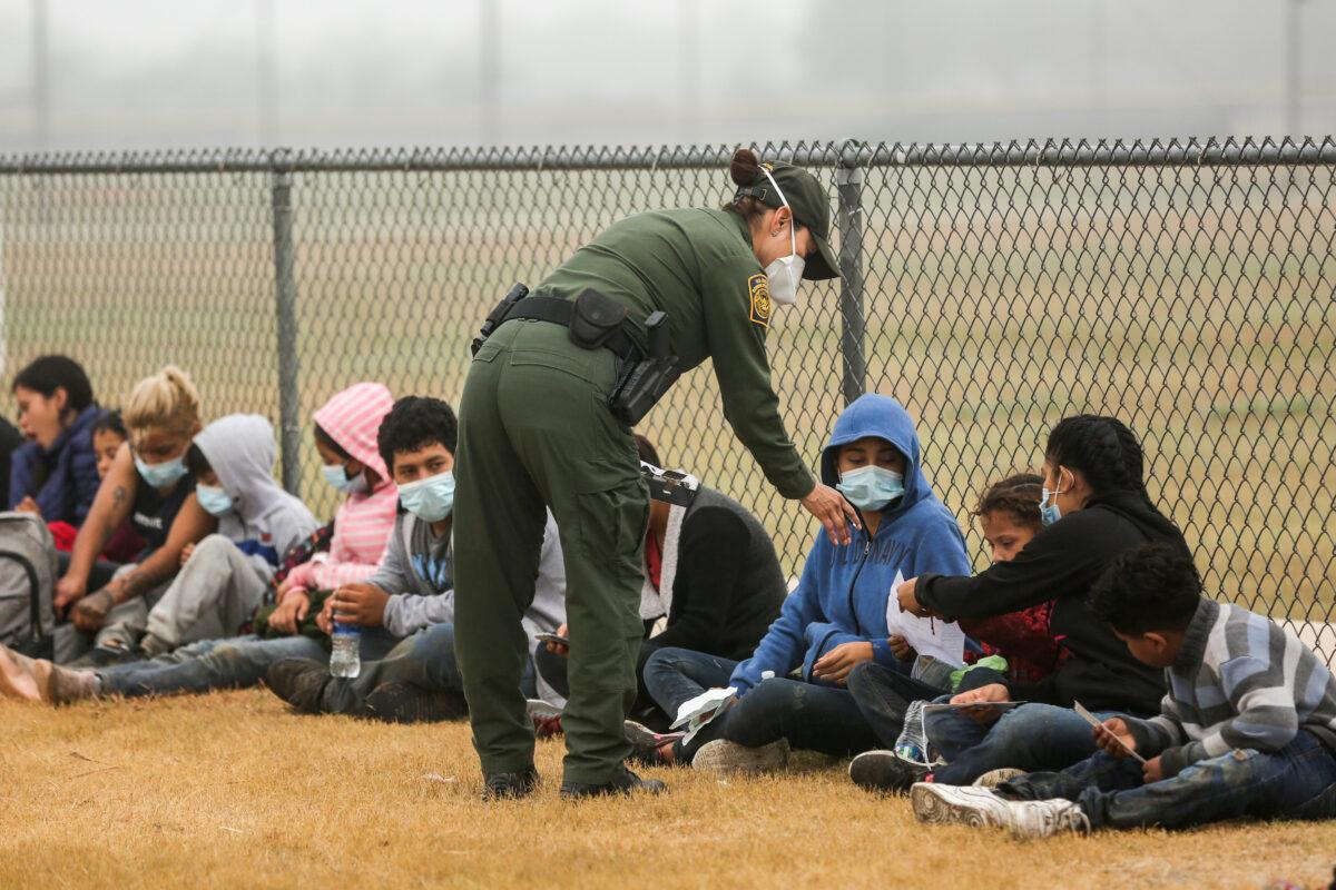 A group of illegal immigrants is processed by Border Patrol after crossing the U.S.-Mexico border in La Joya, Texas, on April 10, 2021. (Charlotte Cuthbertson/The Epoch Times)