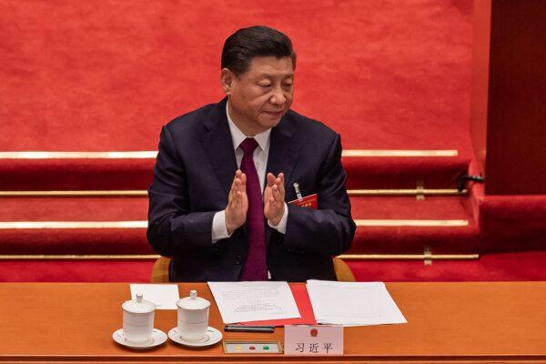 Chinese leader Xi Jinping applauds during the closing session of the National Peoples Congress at the Great Hall of the People in Beijing on March 11, 2021. (Nicolas Asfouri/AFP via Getty Images)