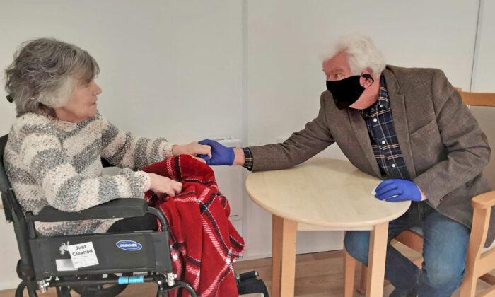 Man, 74, Gets to Hold the Hand of His Wife in Care Home for the First Time in 8 Months