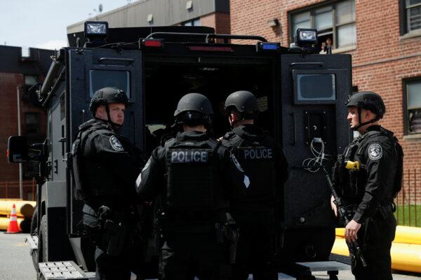 Law enforcement officers stand near the place where the shooter barricaded himself, after a shooting at a Stop and Shop grocery store, in Hempstead, N.Y., on April 20, 2021. (Shannon Stapleton/Reuters)