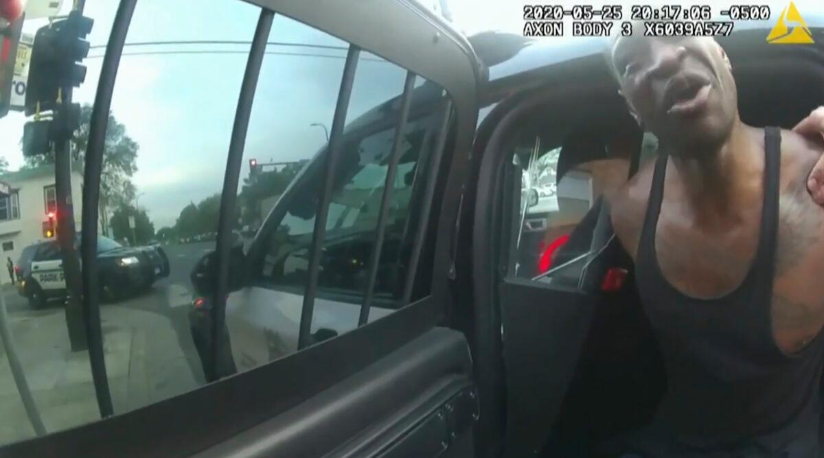  In this image from police bodycam video, Minneapolis police officers attempt to place George Floyd in a police vehicle, on May 25, 2020, outside Cup Foods in Minneapolis, as it is shown in the trial of former Minneapolis police Officer Derek Chauvin in the death of Floyd, at the Hennepin County Courthouse in Minneapolis, Minn., on March 31, 2021. (Court TV via AP/Pool)