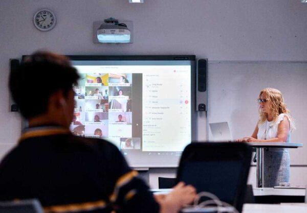 A teacher is seen demonstrating a virtual classroom at Glenunga High School in Adelaide, April 3, 2020. (AAP Image/David Mariuz)