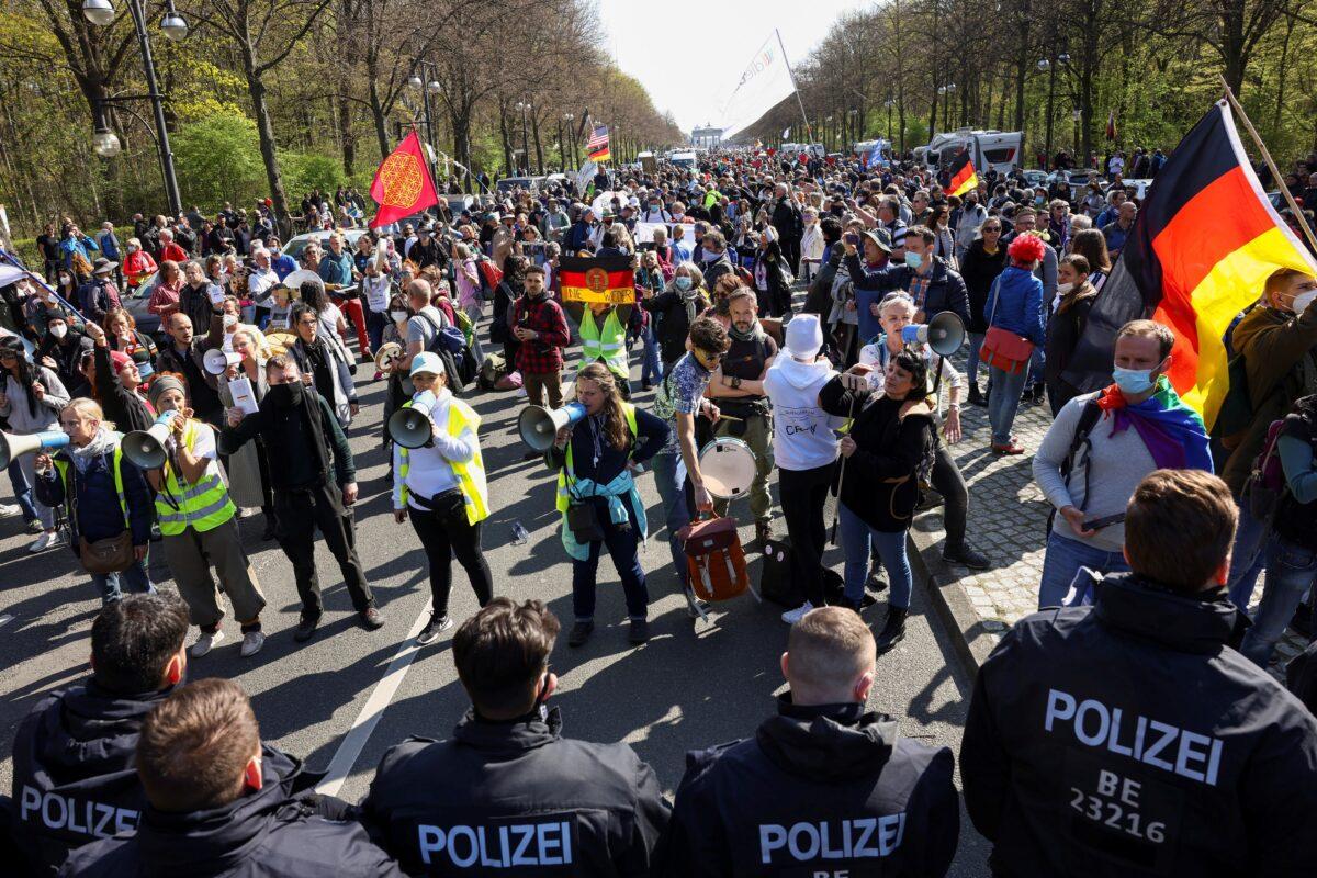Members of the police stand guard as people protest against the German government measures to curb the spread of COVID-19, as the lower house of parliament discusses amendments to the Infection Protection Act, in Berlin, on April 21, 2021. (Christian Mang/Reuters)