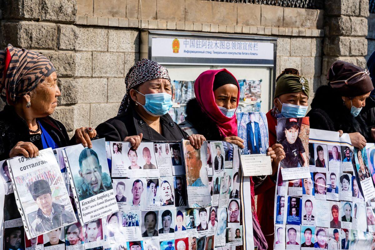 A group of female protestors demand safe passage home for their relatives, who are missing, jailed or trapped in China's Xinjiang region outside the Chinese consulate in Almaty, Kazakhstan on March 9, 2021. (Abduaziz Madyrovi/AFP via Getty Images)