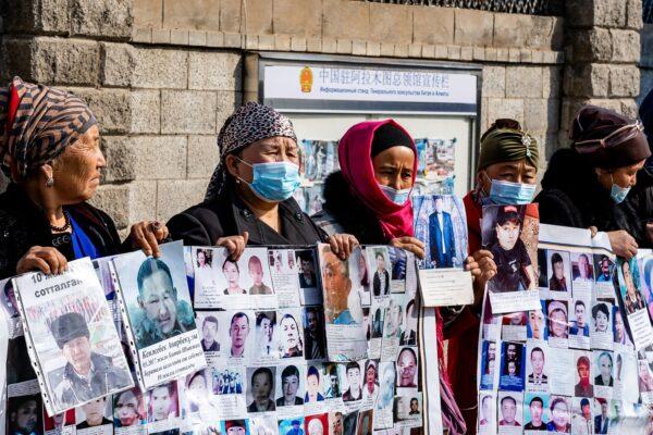 A group of female protestors demand safe passage home for their relatives, who are missing, jailed, or trapped in China's Xinjiang region outside the Chinese consulate in Almaty, Kazakhstan on March 9, 2021. (Abdulaziz Madyrovi/AFP via Getty Images)