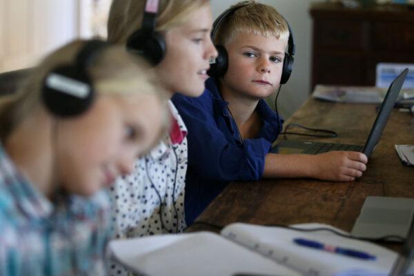 Three children do school work at their family home and cattle property on April 05, 2020, in Tarpoly Creek, Australia. (Lisa Maree Williams/Getty Images)
