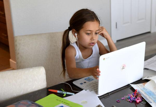 An third grade student takes an online class at a friend's home during her first week of distance learning in Las Vegas on Aug. 25, 2020. (Ethan Miller/Getty Images)