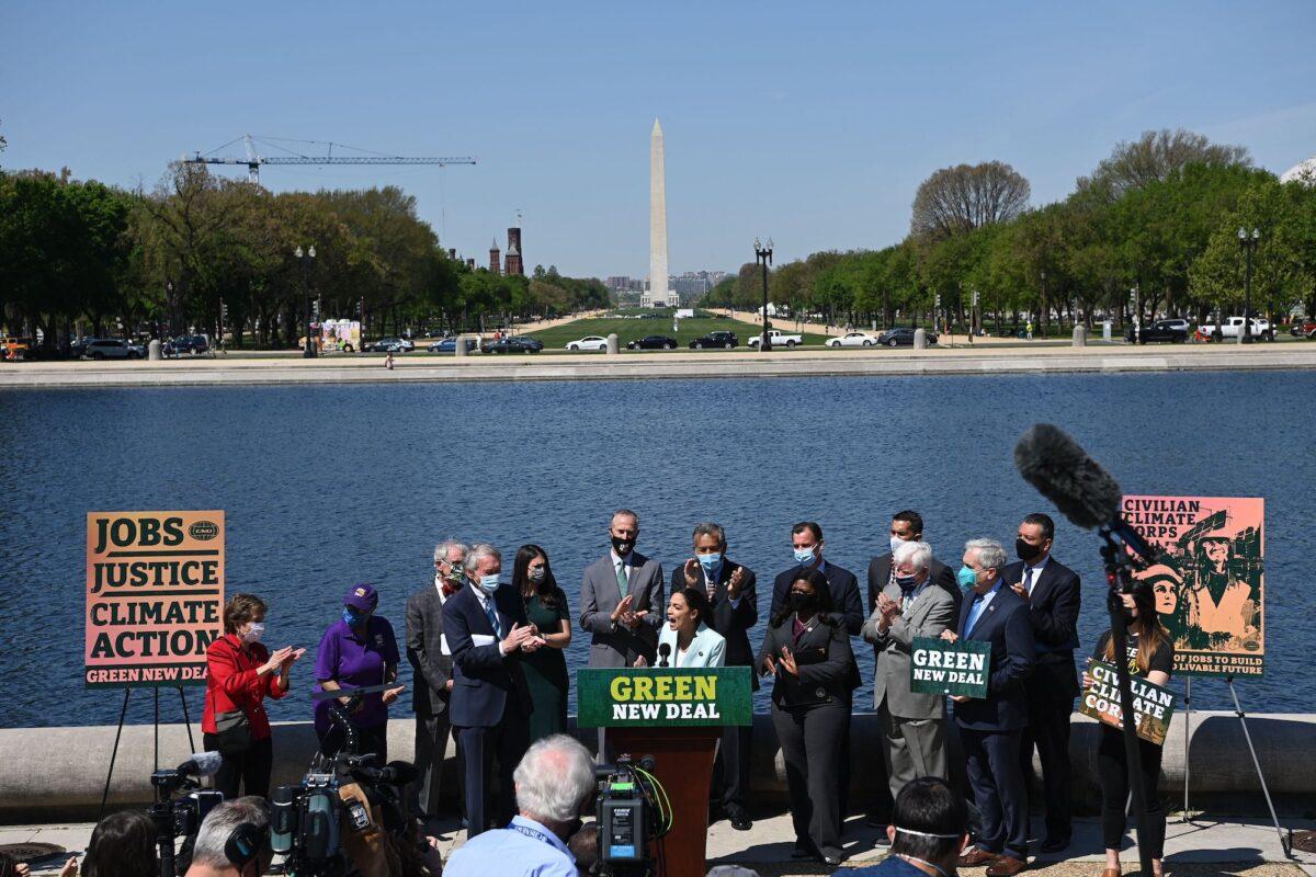 Rep. Alexandria Ocasio-Cortez (D-N.Y.), next to Sen. Ed Markey (D-Mass.), speaks during a press conference to re-introduce the Green New Deal in front of the Capitol in Washington on April 20, 2021. (Mandel Ngan/AFP via Getty Images)