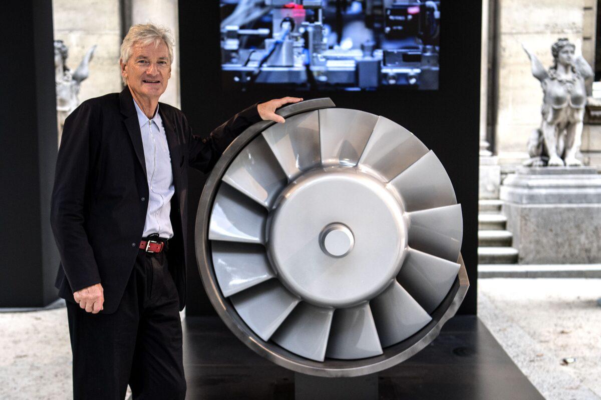 British industrial design engineer and founder of the Dyson company, James Dyson, poses next to the model of an engine during a photo session at a hotel in Paris on Oct. 11, 2018. (Christophe Archambault/AFP via Getty Images)