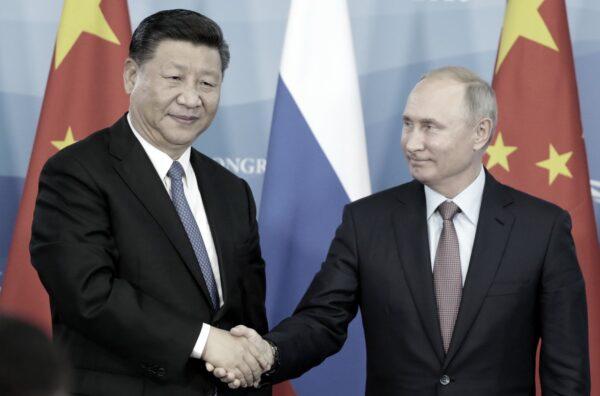 Russian President Vladimir Putin (R) shakes hands with Chinese leader Xi Jinping during a signing ceremony following the Russian–Chinese talks on the sidelines of the Eastern Economic Forum in Vladivostok on Sept. 11, 2018. (Sergei Chirikov/AFP/Getty Images)