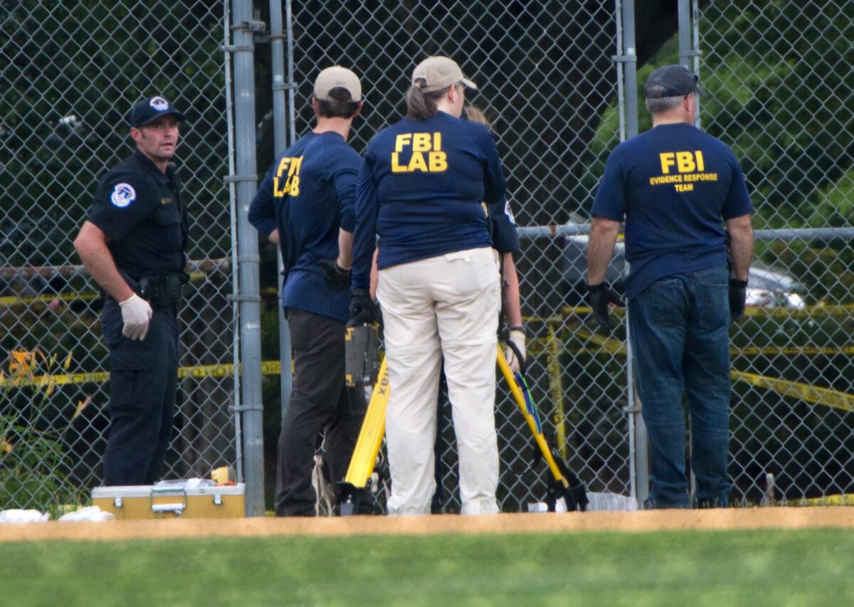 Members of the FBI gather at the crime scene after a shooting during a practice of the Republican congressional baseball team at Eugene Simpson Stadium Park in Alexandria, Va., on June 14, 2017. (Paul J. Richards/AFP via Getty Images)