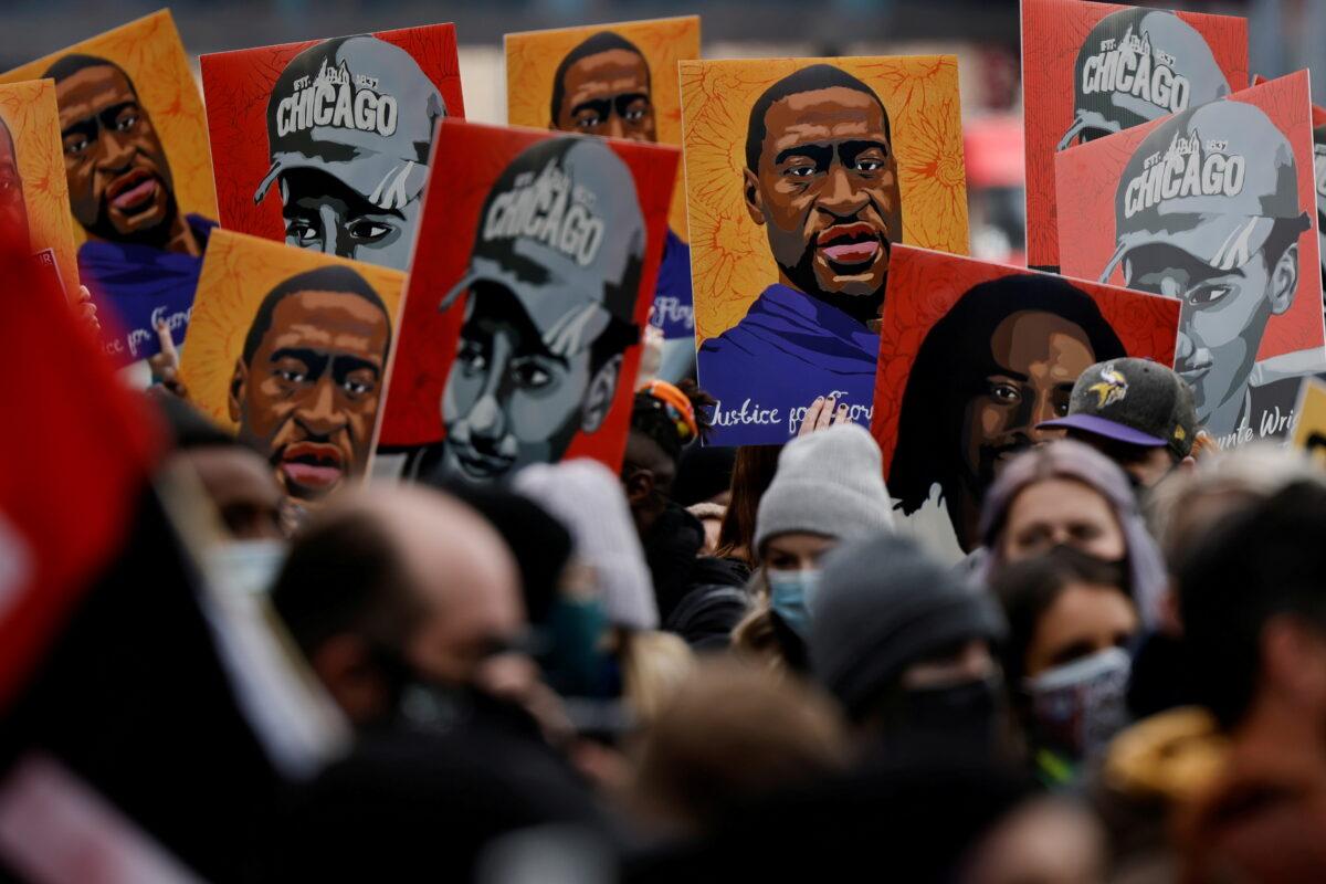 People hold placards with paintings of George Floyd, Daunte Wright and Philando Castile after the verdict in the trial of former Minneapolis police officer Derek Chauvin, found guilty of the death of George Floyd, in front of Hennepin County Government Center, in Minneapolis, Minn., on April 20, 2021. (Carlos Barria/Reuters)
