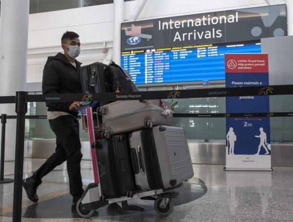 A passenger traveling from New Delhi arrives at Pearson Airport in Toronto, Canada, on April 21, 2021. (The Canadian Press/Frank Gunn)