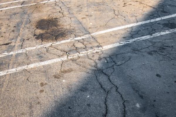 Cracking asphalt in Fullerton, Calif., on Dec. 10, 2020. (John Fredricks/The Epoch Times)