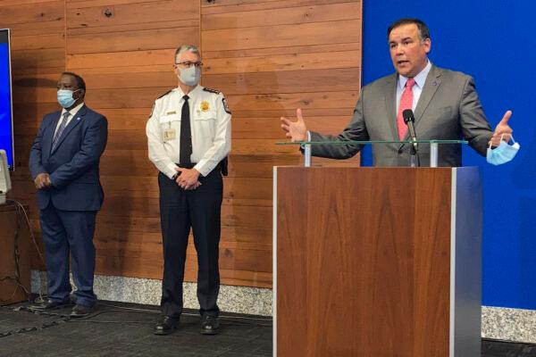 Columbus Mayor Andrew Ginther (R) speaks during a news conference as Columbus Public Safety Director Ned Pettus Jr. (L) and interim Police Chief Michael Woods (C) listen, in Columbus, Ohio, on April 21, 2021. (Andrew Welsh-Huggins/AP Photo)