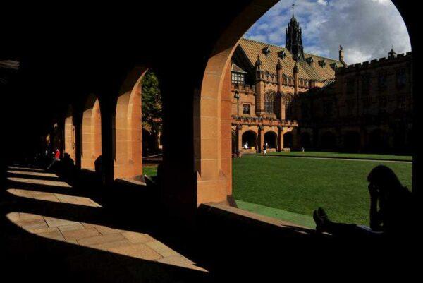 Students sit next to The Quadrangle at The University of Sydney on May 8, 2013, in Sydney, Australia (AAP Image/Paul Miller)